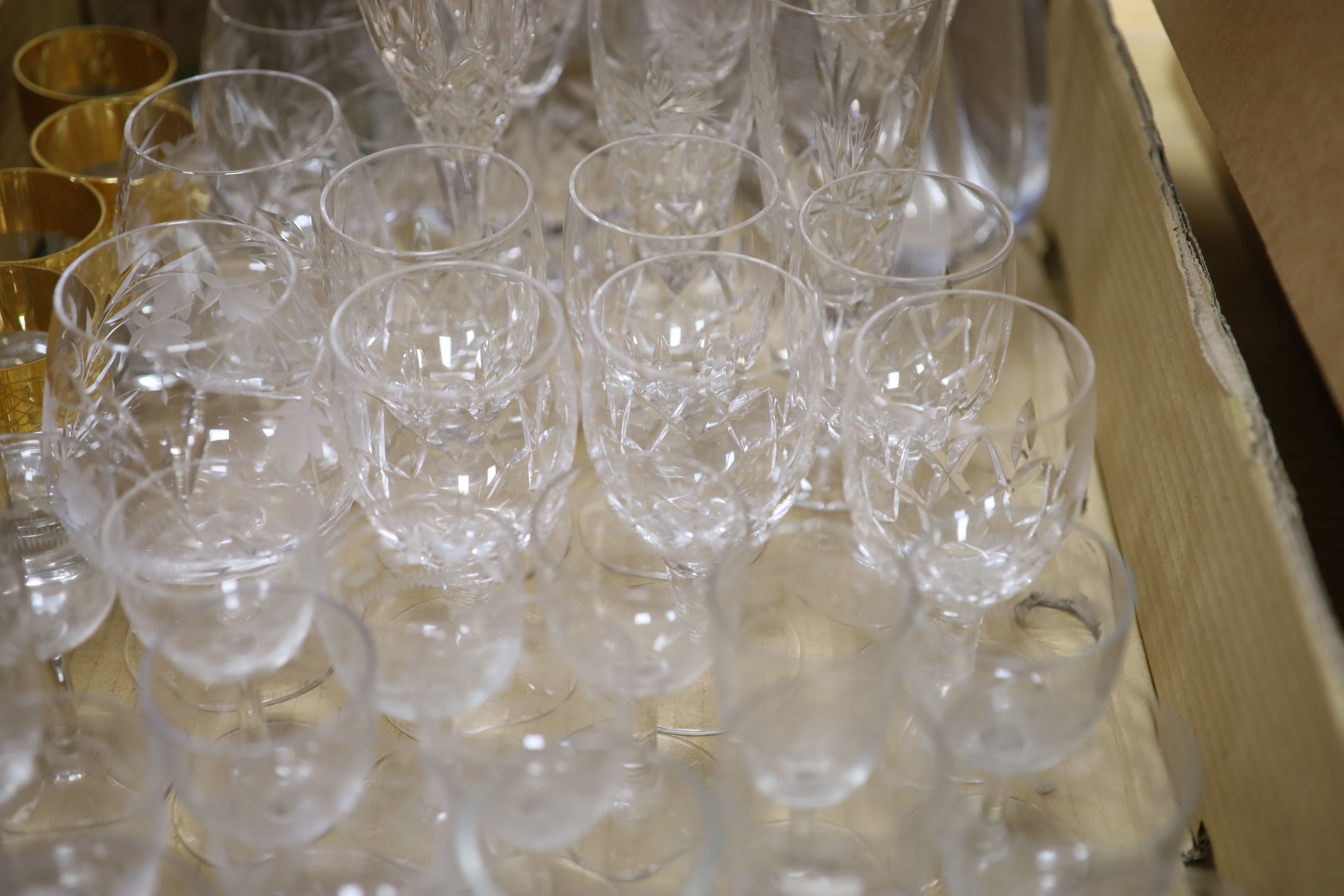 Eight cut glass decanters and mixed drinking glasses